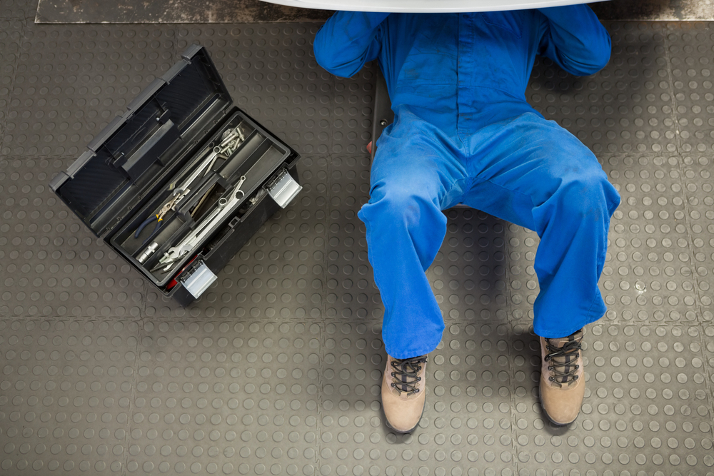 Man sits beside toolbox - keep yours clean to ensure safety onsite